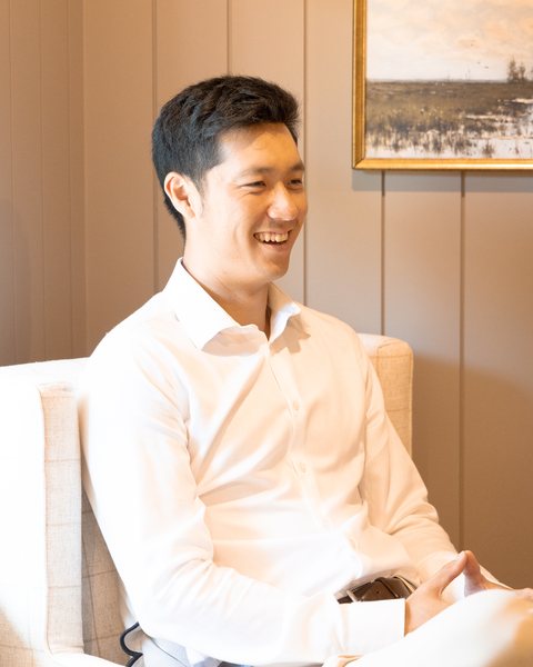 Chih Chi sitting in a show home, laughing